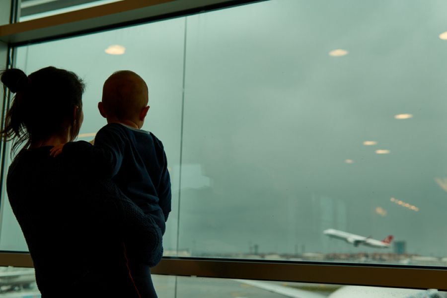Mother watching planes take off at an airport