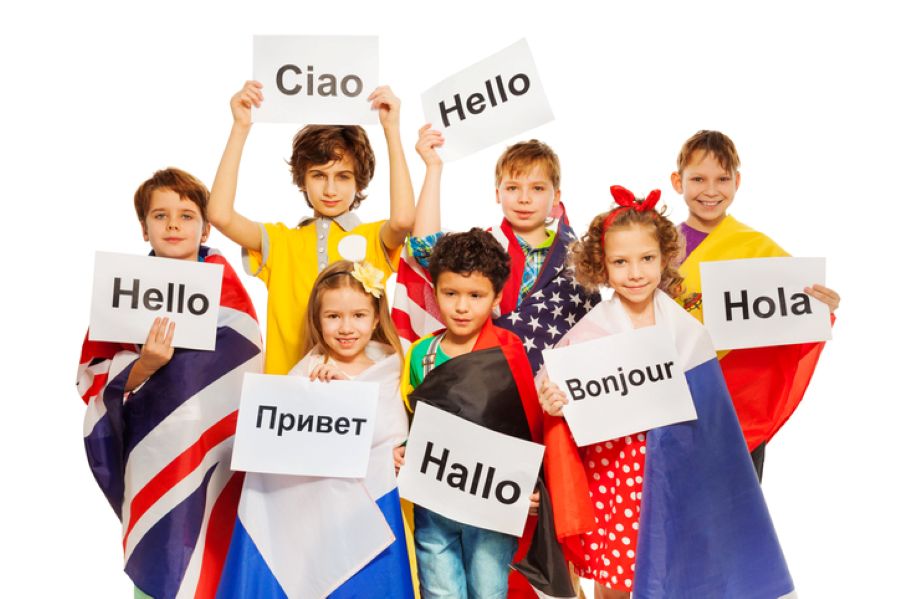 Children from different countries holding handwritten greeting signs, symbolising international and cross-border families