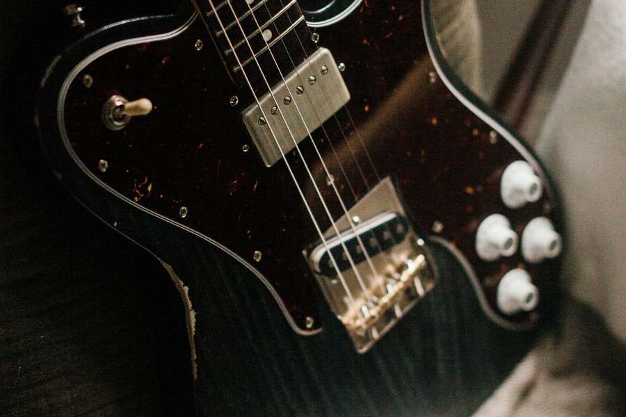 Close-up of a vintage electric guitar's pickups and controls, illustrating hidden value in personal possessions during divorce