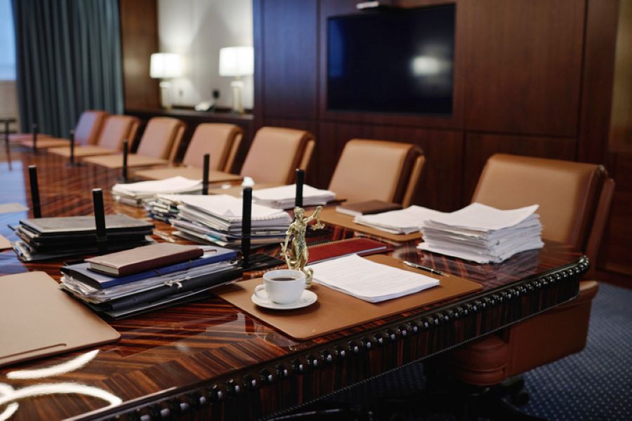 Empty private meeting room with a long table and chairs, set up for a Private FDR hearing in a financial remedy case